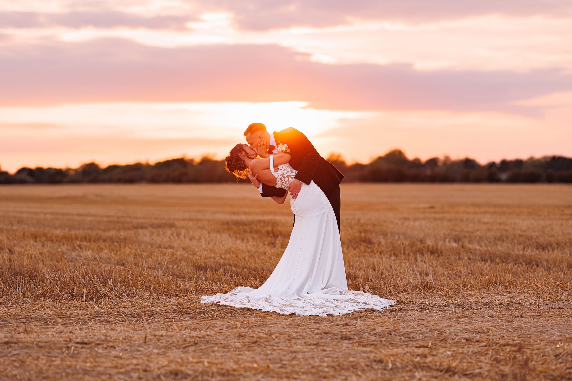 a man and woman kissing in a field